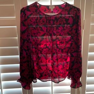 Black floral blouse with ruffled wrist and covered buttons